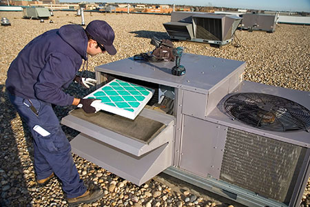 A technician maintaining an HVAC unit
