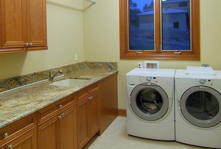 A bathroom with two sinks and a washer.