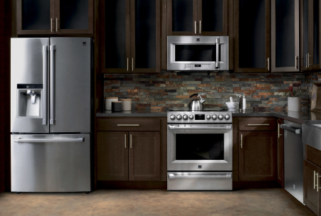 A kitchen with stainless steel appliances and wooden cabinets.