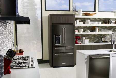 A kitchen with a refrigerator and stove in it