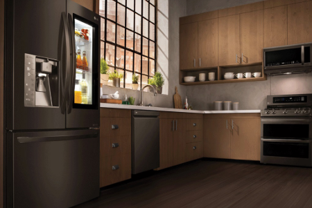 A kitchen with an open window and wooden cabinets.