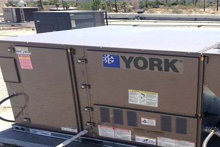 A york air conditioner is on the side of a building.